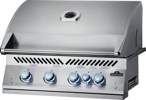 Angled view of the Napoleon Grills Built-In 700 Series 32-Inch 5-Burner Gas Grill Head with the lid closed and blue-lit control knobs, showcasing the grill's elegant design.