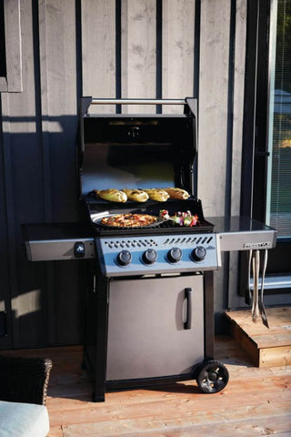 The Napoleon Grills Freestyle 425 4-Burner Gas Grill in action, enhancing the outdoor cooking experience.