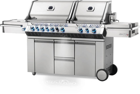 Angled view of Napoleon Grills Prestige PRO™ 825 RSIB Grill showcasing the stainless steel finish and illuminated blue control knobs.