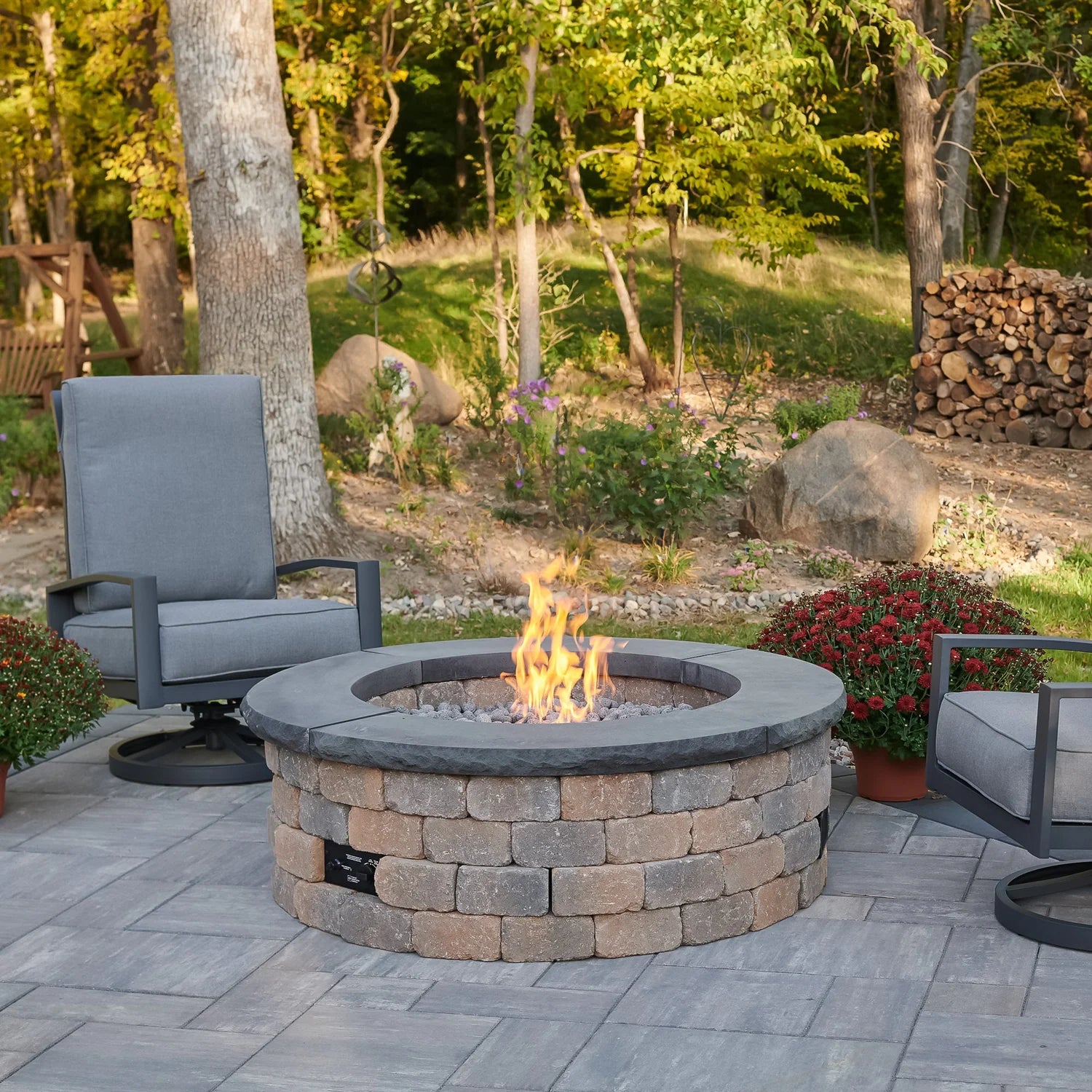 Outdoor Greatroom Co Bronson Block Gas Fire Pit Kit Round in use, featuring a charcoal top, SKU BRON52-K.