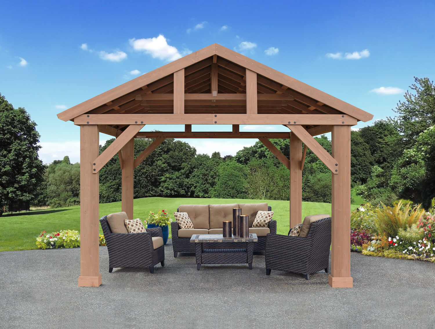 The Meridian Cedar 14 x 12 Pavilion by Yardistry in a garden setting with furniture under.