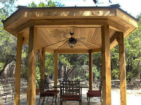 ceiling fan in a gazebo with outdoor dining set