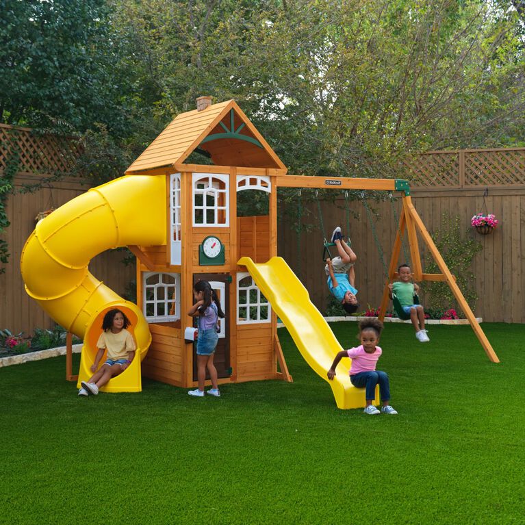 children playing on the kidkraft castlewood wooden swing set with clubhouse