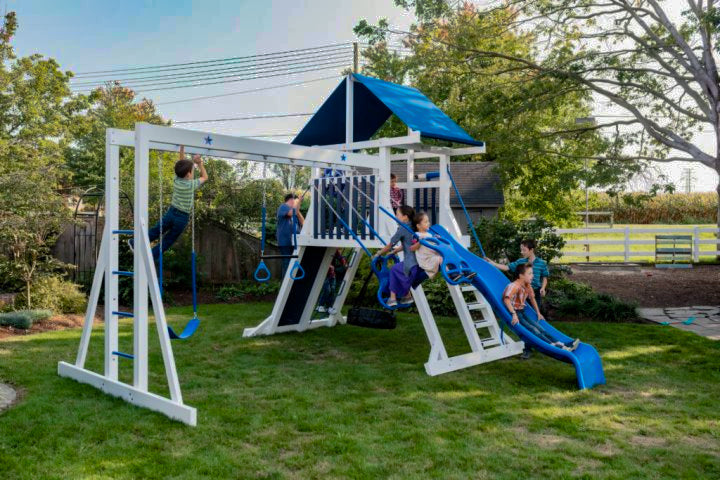 children playing on white vinyl playset with monkey bars