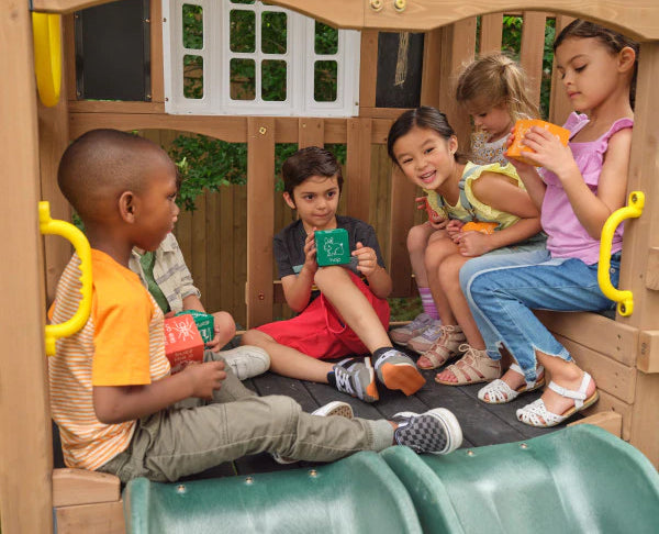 children sitting inside the Kidkraft Timberlake Playset