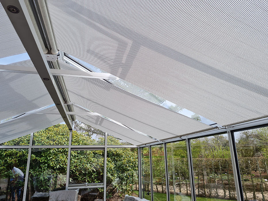 Retractable shade system for Exaco Janssen Modern and Royal Victorian greenhouses, provides temperature control and protects plants from excessive sunlight.