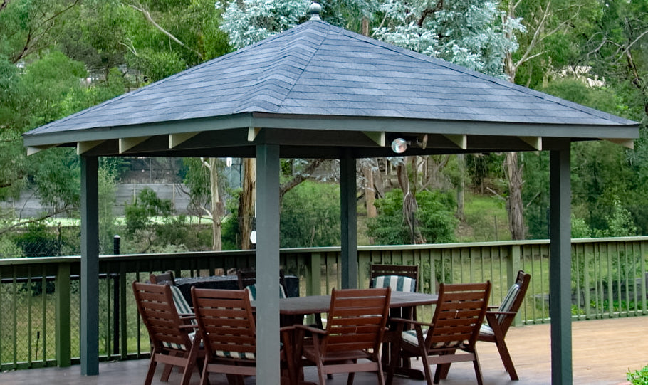 gazebo with shingles on roof and outdoor dining set