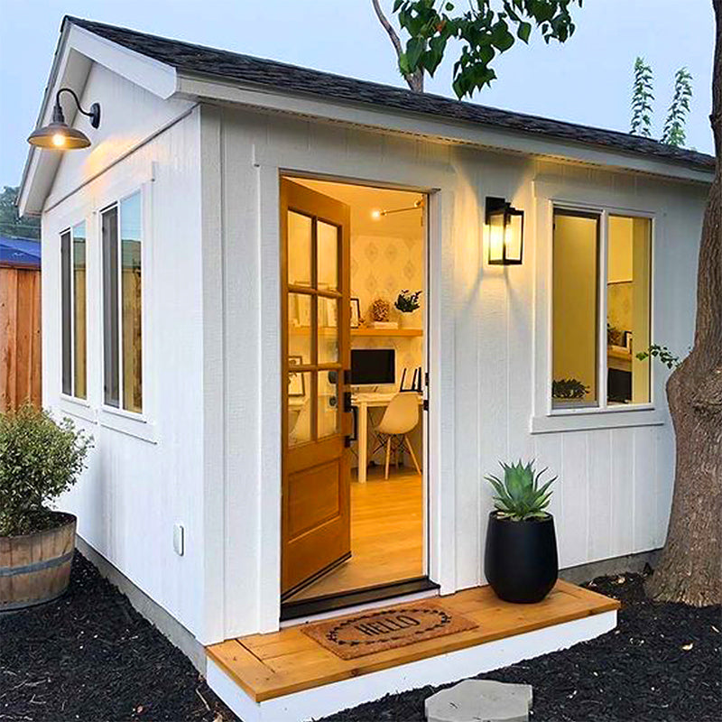 large white wooden storage shed converted into an office