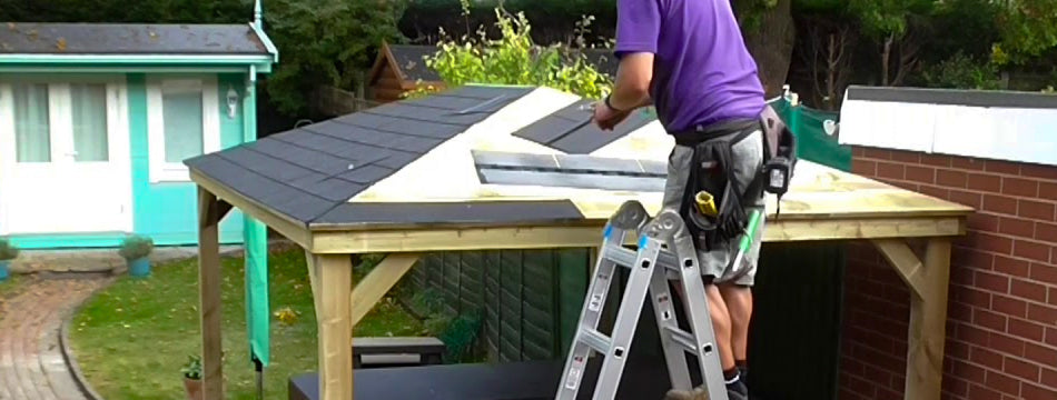 man installing shingles on a gazebo roof