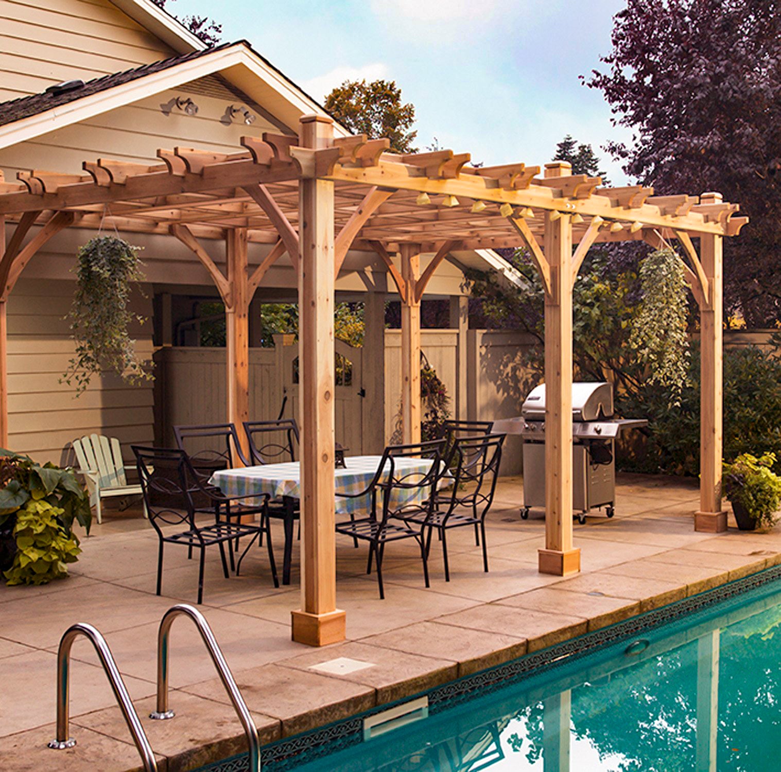 outdoor living today breeze pergola with outdoor dining set and grill beside a pool