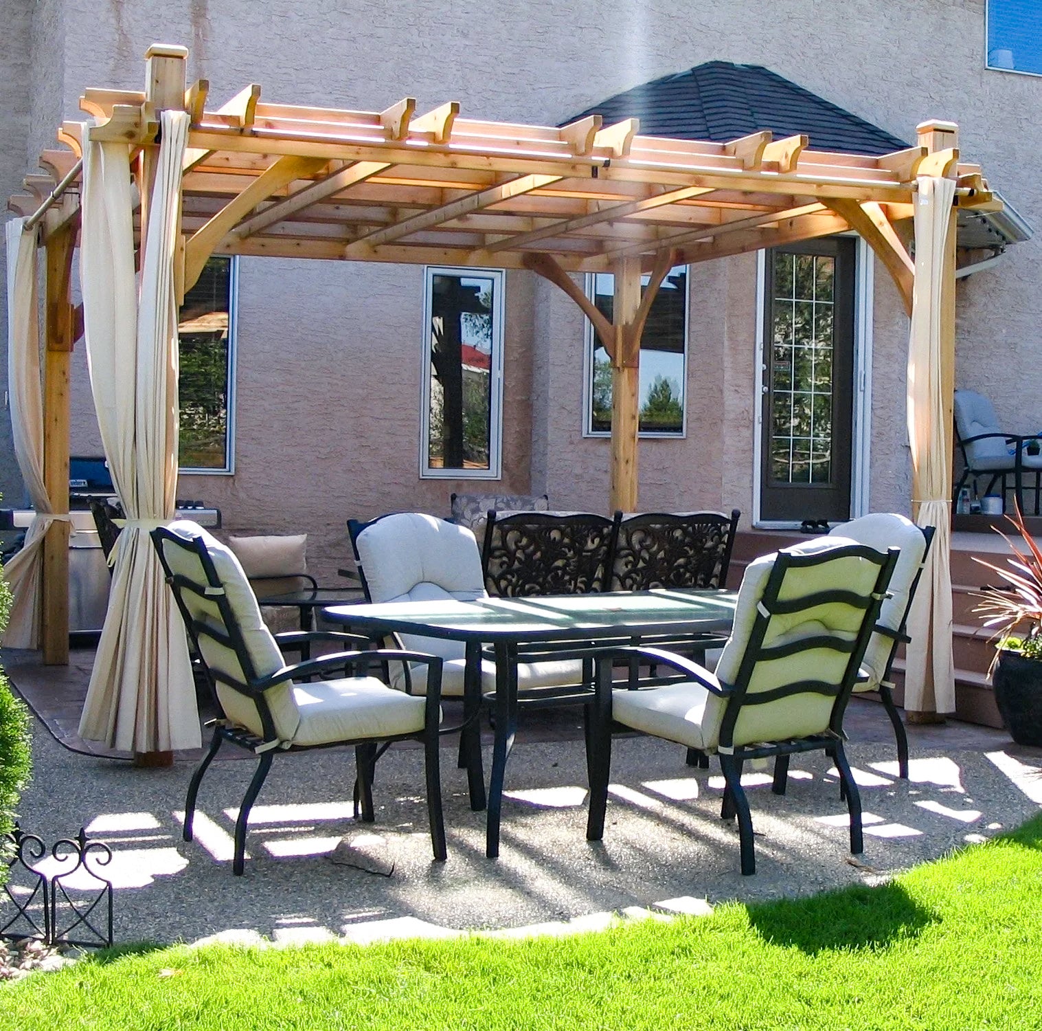 outdoor living today cedar pergola with curtains and outdoor furniture on a pavement
