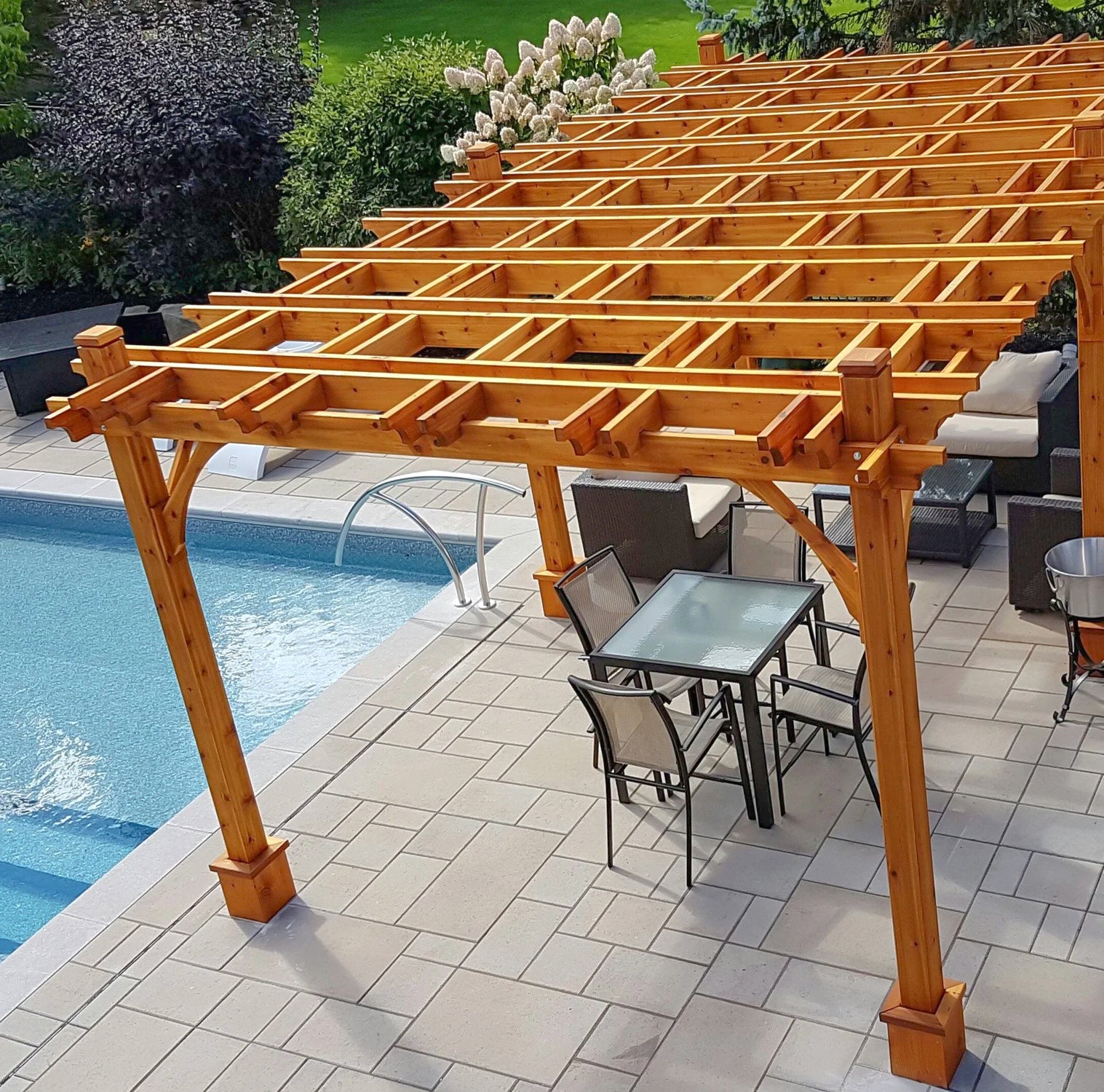 outdoor living today cedar pergola with outdoor furniture on pavers beside pool