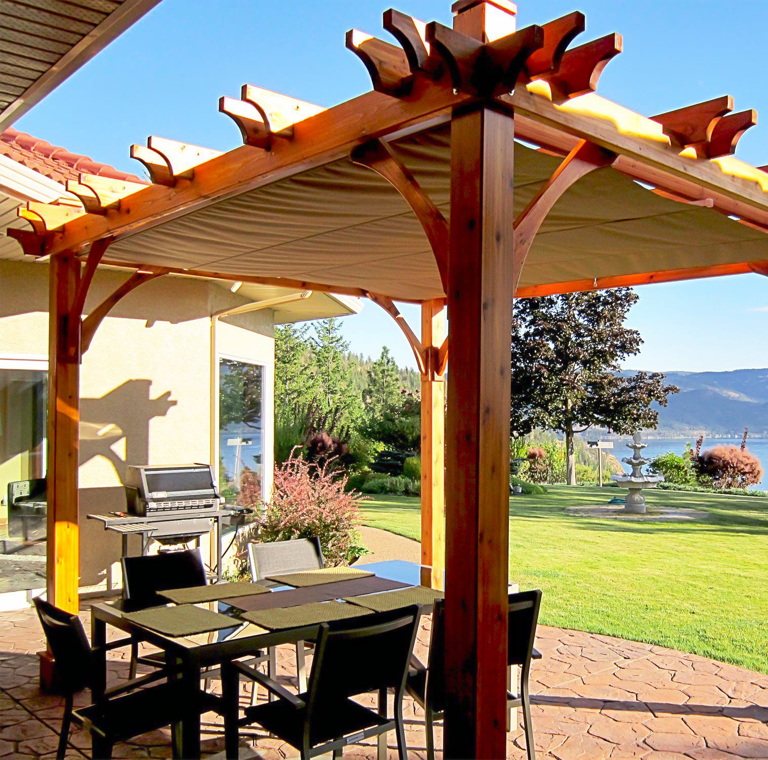outdoor living today pergola with retractable canopy and outdoor furniture