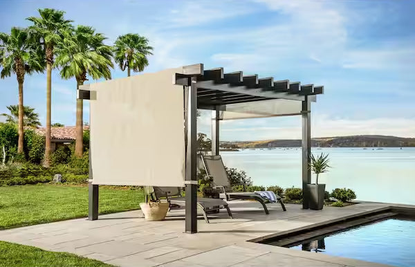 Sojag Yamba 10x13 ft Pergola on a patio by a poolside with a scenic lake view, surrounded by lush palm trees.