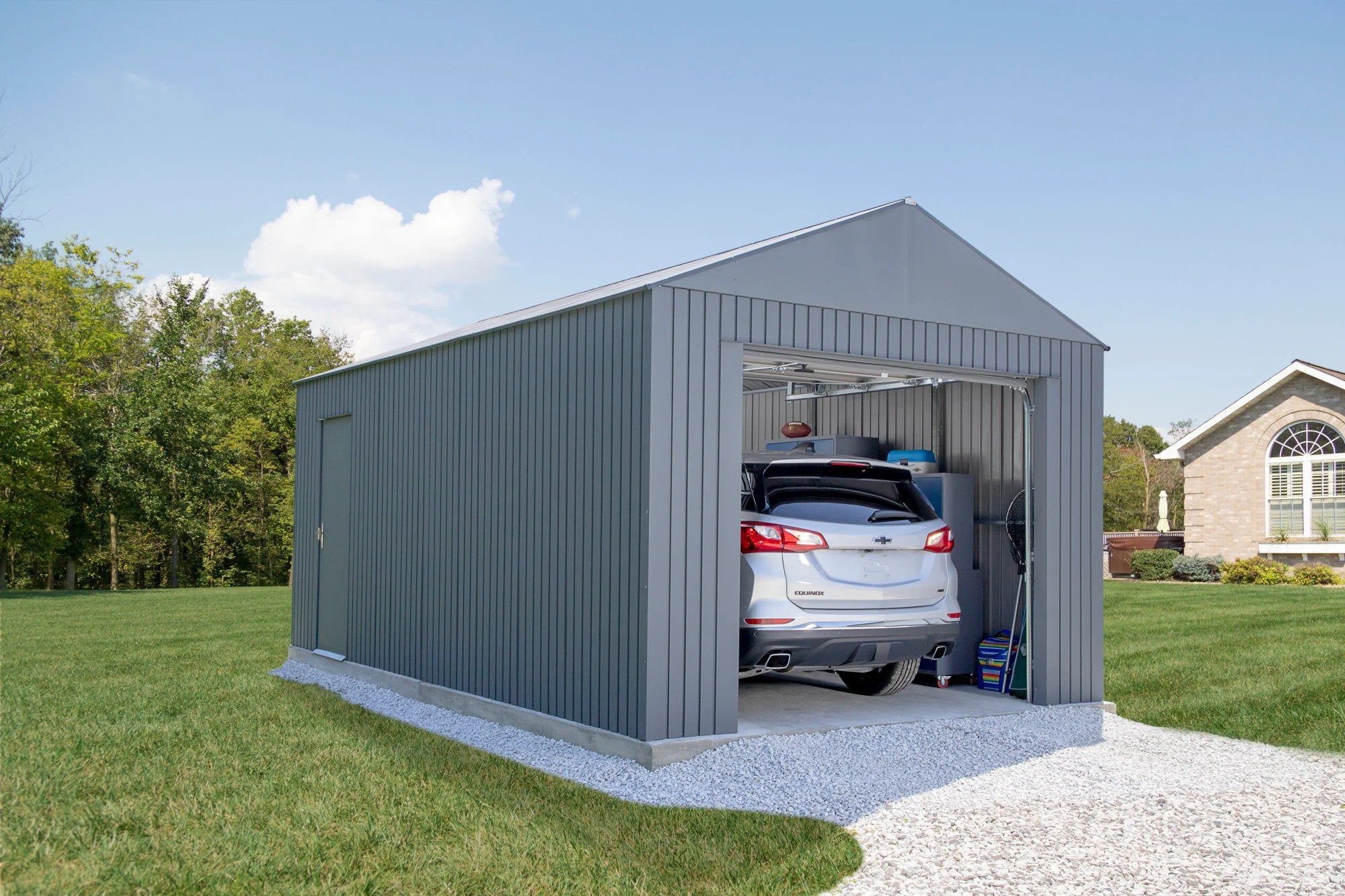 sojag everest detached garage in charcoal with roll up and side entry swing door and vehicle parked inside