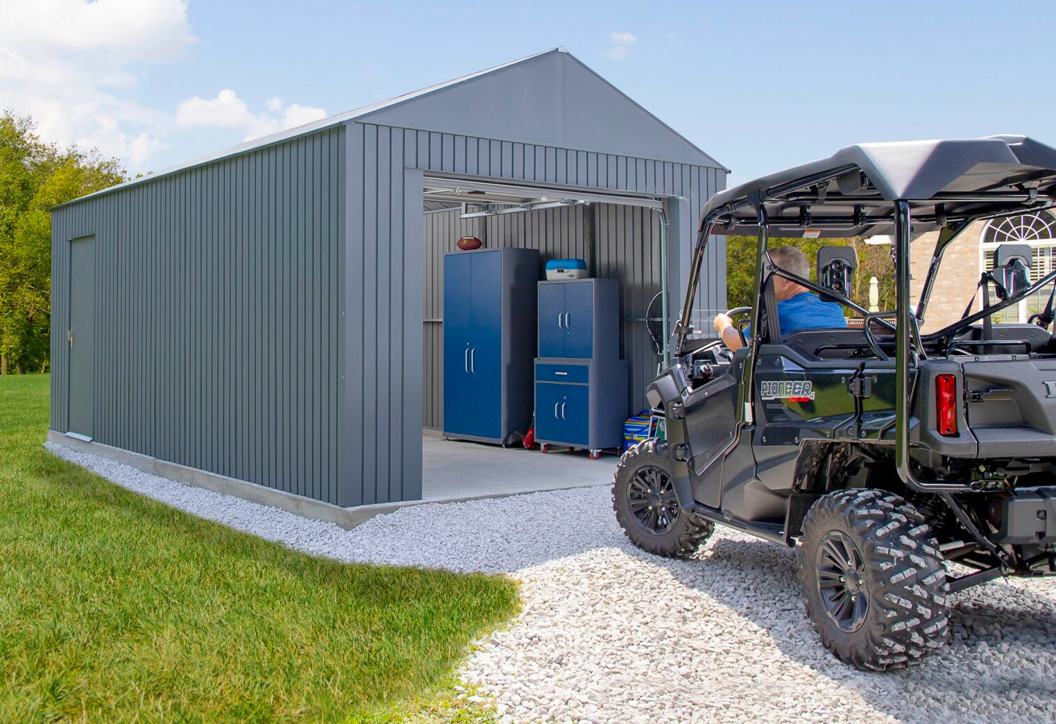 detached garage with roll up door and side entry swing door and atv parking inside