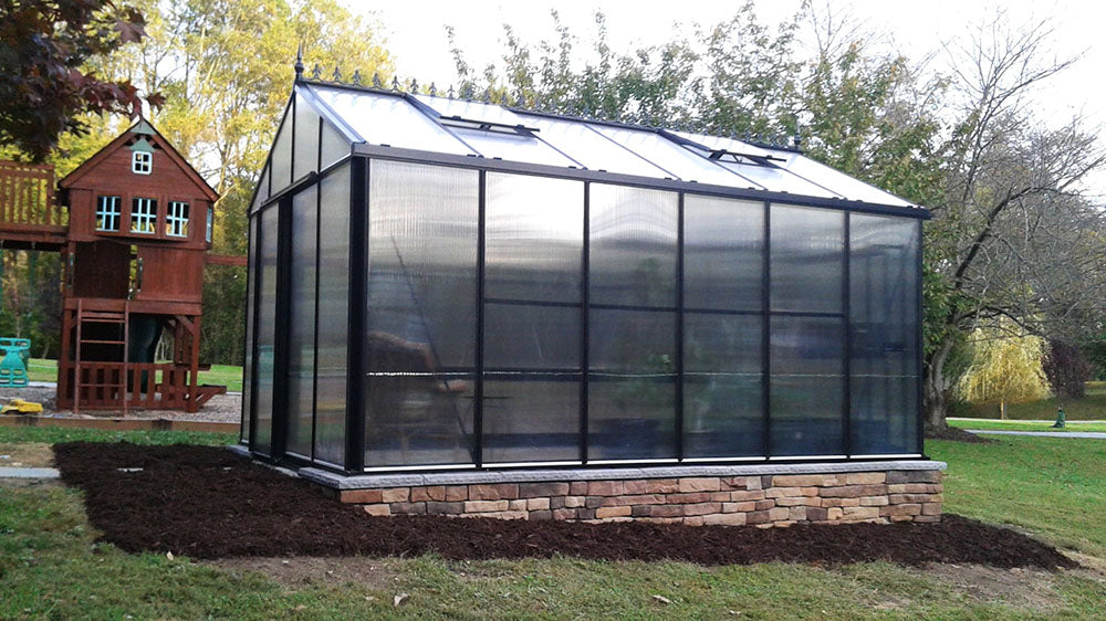 Victorian Greenhouse with polycarbonate panels in a backyard.