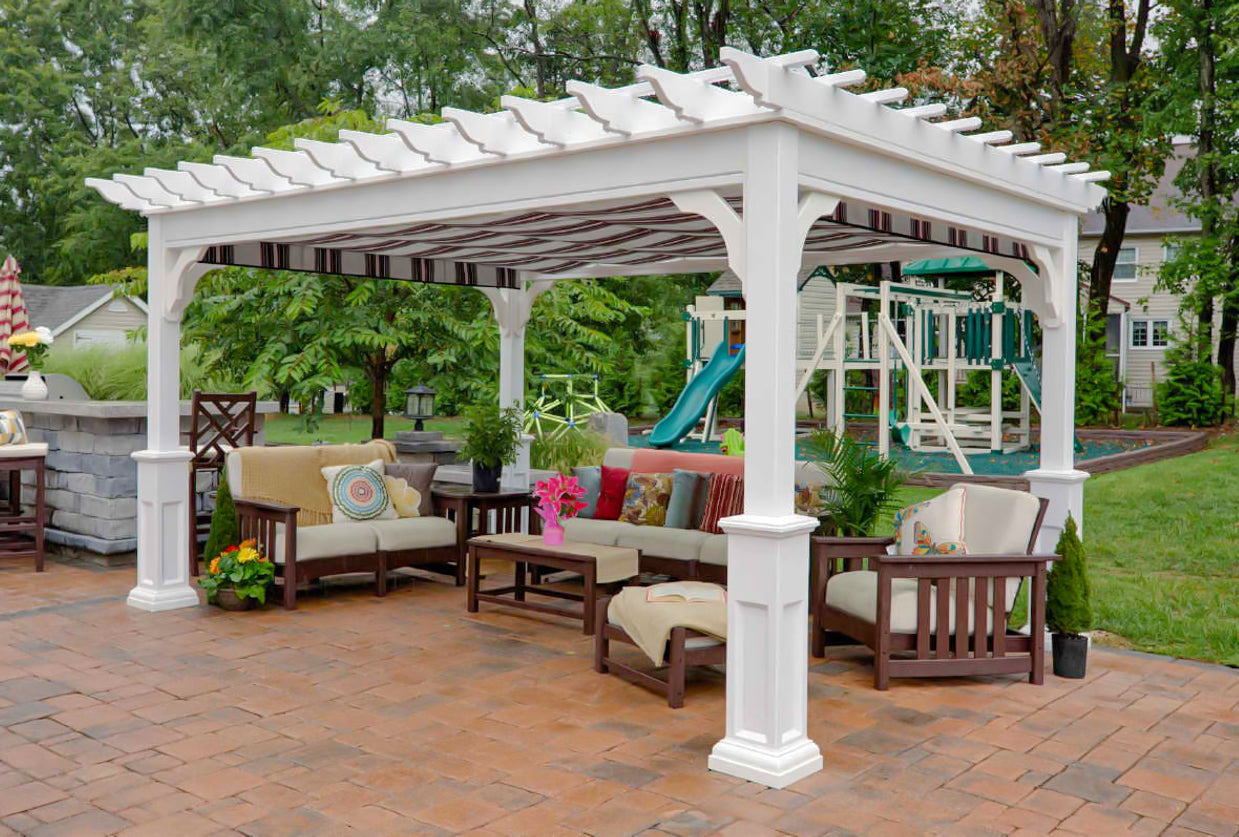 white pergola with retractable canopy with outdoor furniture on a paver