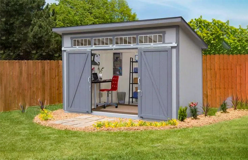 wooden storage shed painted gray converted into an office