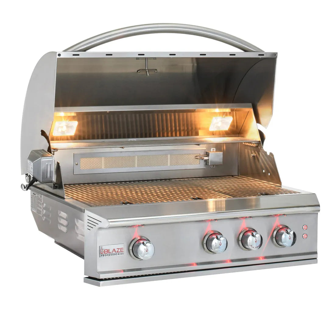 Full view of the Blaze Grills Professional LUX 3-4 Burner Built-In Gas Grill with the lid open, showcasing the rotisserie burner, cooking grates, and control knobs illuminated by interior lights.