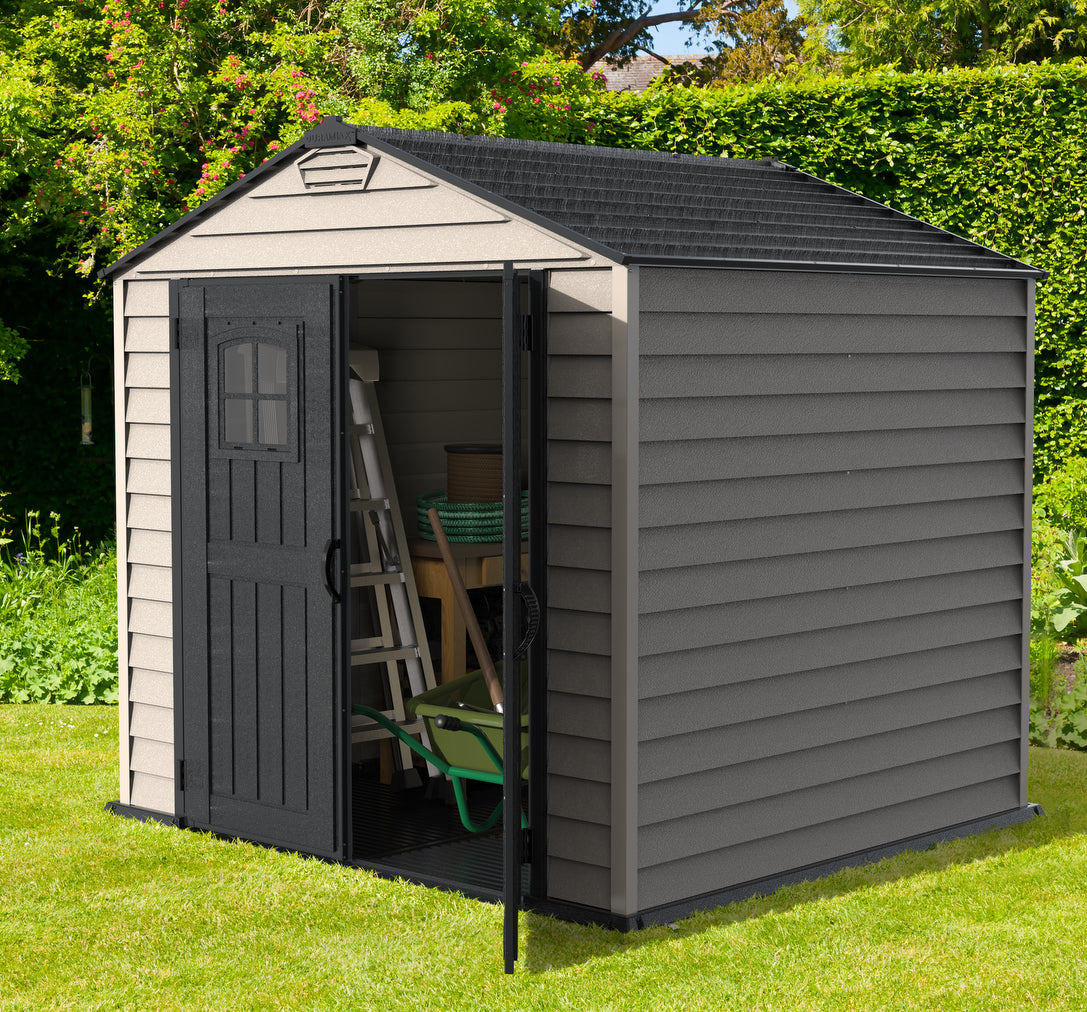 Open view of Duramax 7x7 StoreMax Plus Shed with molded floor, displaying garden tools and equipment storage capabilities in a vibrant garden setting.