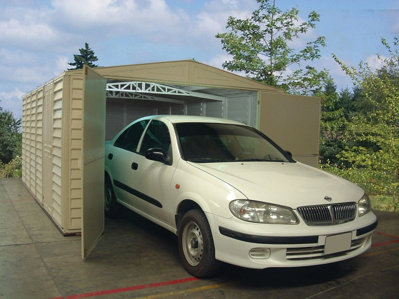 A car exiting the Duramax Vinyl Garage 10.5x15.5 that is placed outdoors.