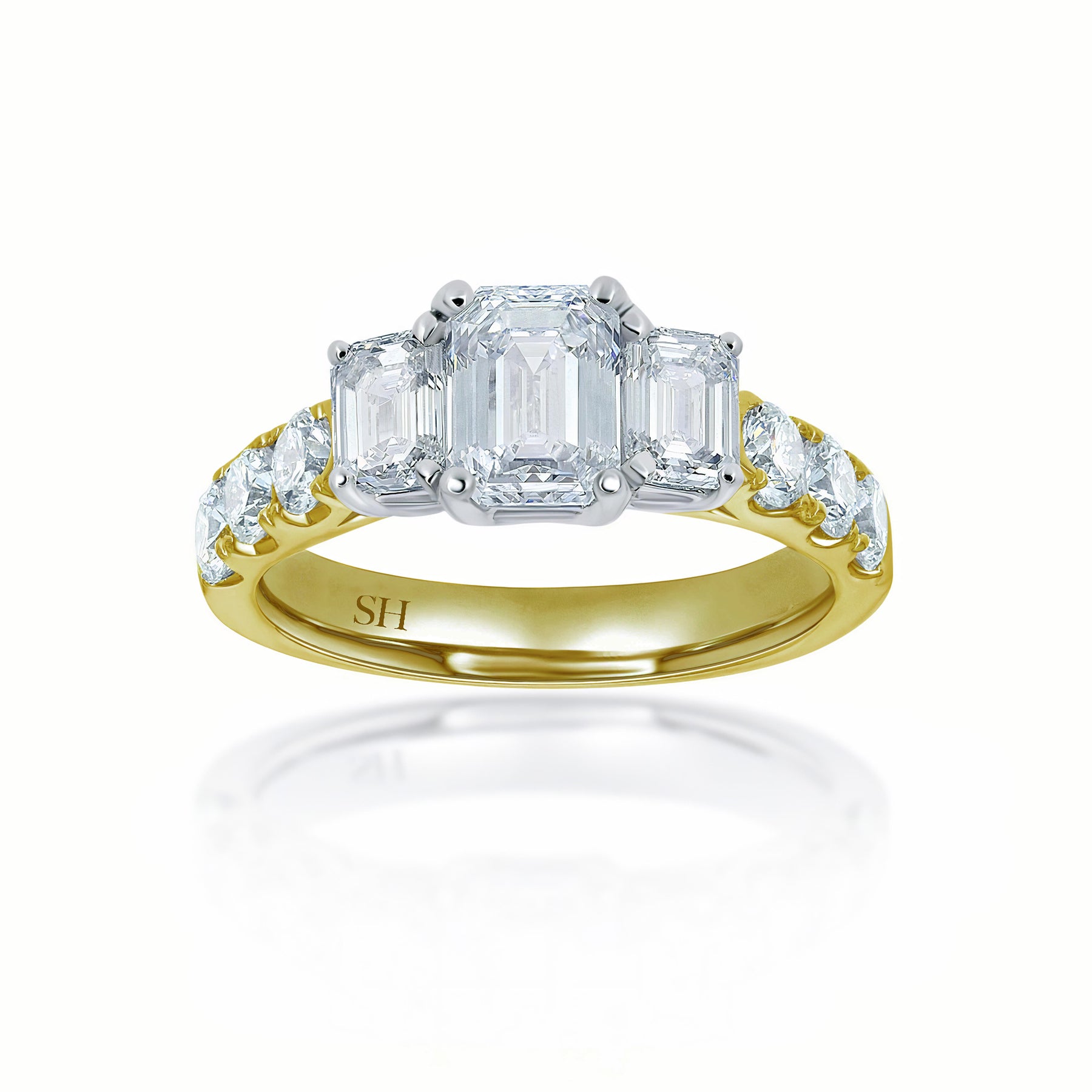 Trilogy Emerald Cut engagement ring with claw set band