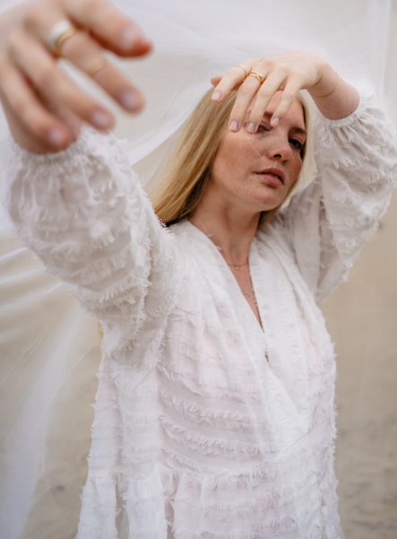 Braut streckt Hand in die Kamera und zeigt ihre Maren Ringe, die sie zur Hochzeit trägt