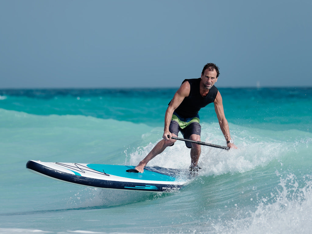 Surfing small waves with an inflatable paddle board