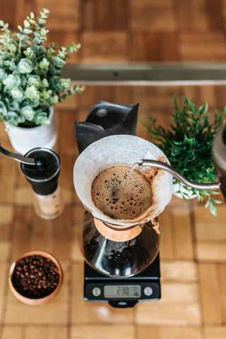 Water being poured into a pour over coffee maker