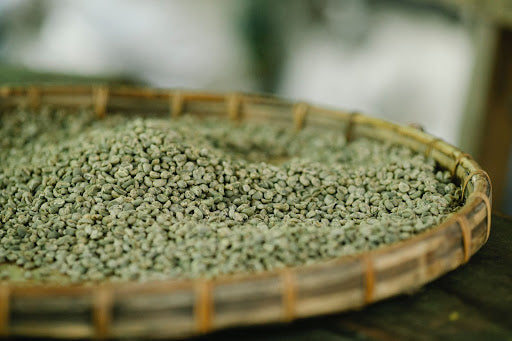 Flat basket of unroasted coffee beans. 