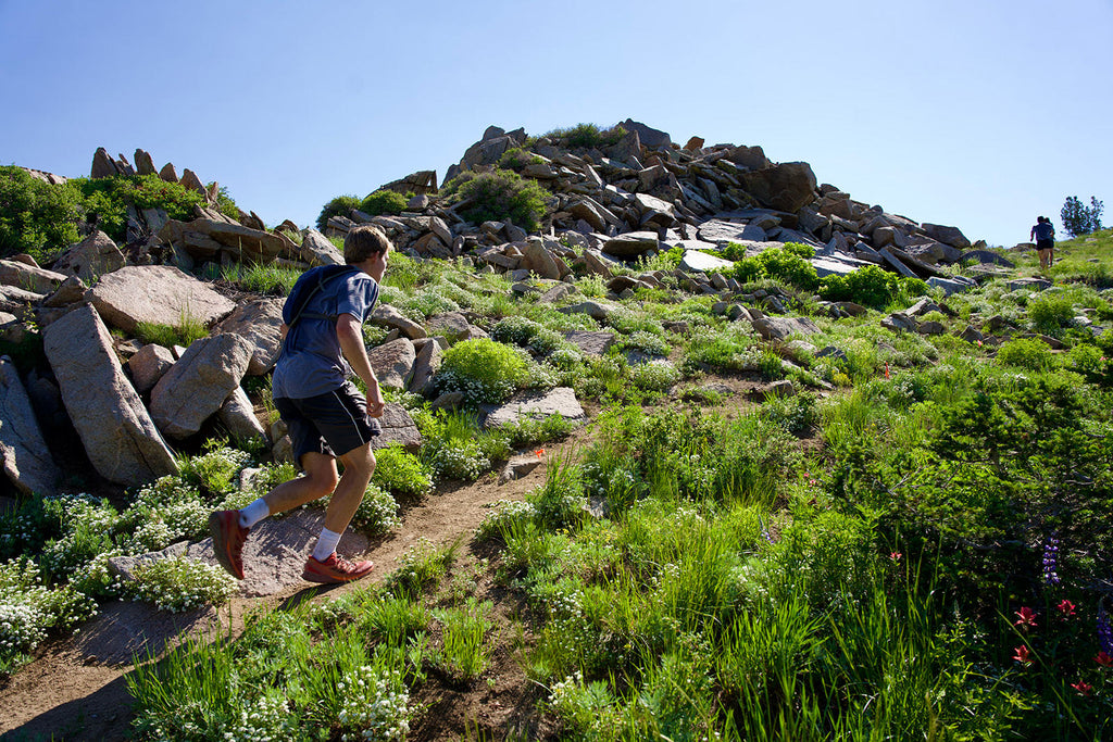 Caffeinated man running uphill in the mountains.