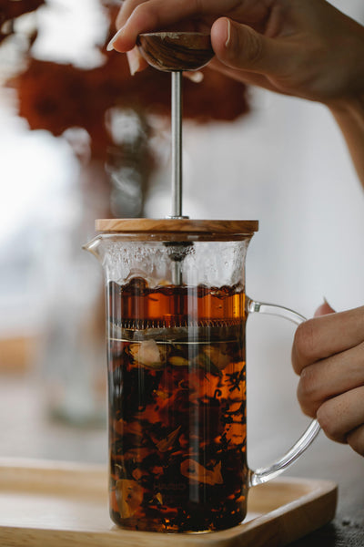 Mix of leaves steeping in a french press.