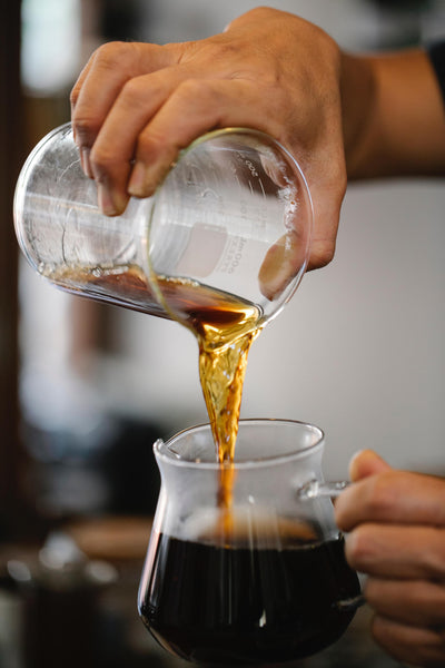 Coffee pouring into a caraffe from decanter.