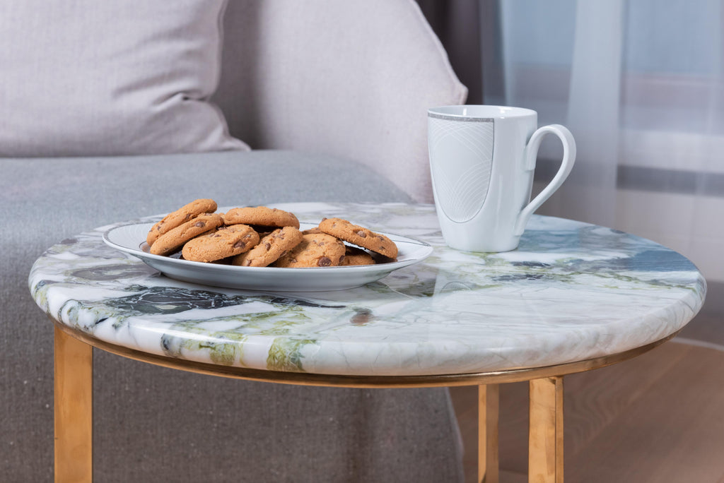Plate of cookies and cup on living room table.