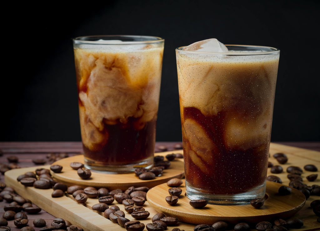 Two glasses of cold brew coffee with additives.