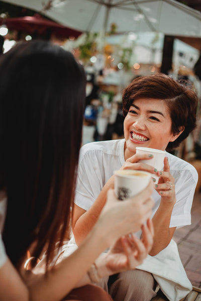 Two happy friends enjoying coffee.