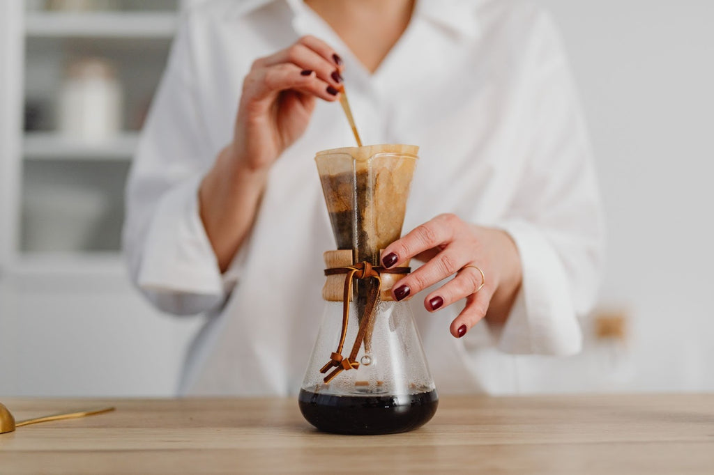 Woman stirring while brewing coffee.