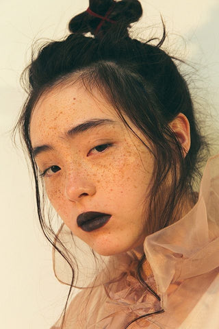 Woman with bold lipstick and minimal makeup