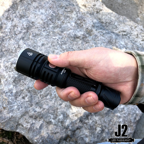 Holding an Acebeam L16 in one hand.