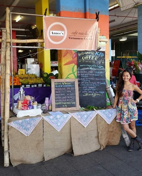 Annee stands next to her original 2014 stall at Rusty's Market 