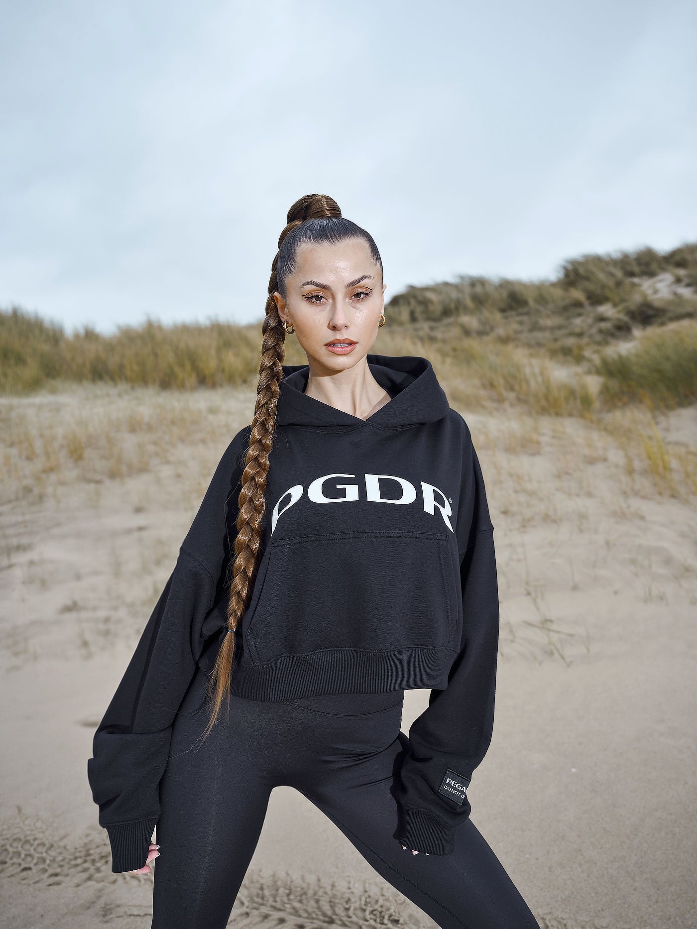 Troms Oversized Cropped Hoodie Black from the 'Do Not Disturb' collection, designed for comfort and relaxation, set against a serene background, symbolizing a break from the fast-paced world.