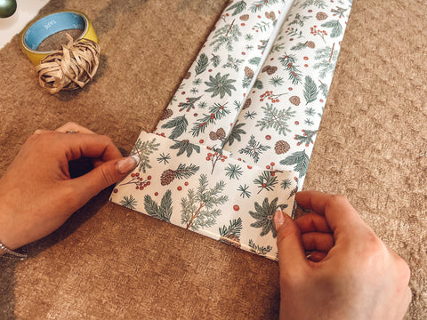 Folding gift wrap upwards - how to wrap a bottle