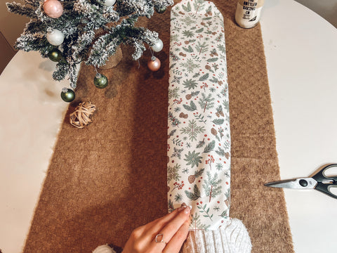 Putting arm into gift wrap - how to wrap a bottle