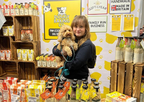 Owner & dog at Doggy Baking Co stand at Crufts