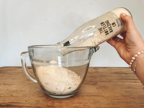 Pouring Bottled Baking Co. mix into bowl