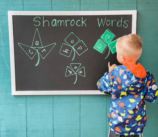 A child doing homeschool lessons on a chalkboard.