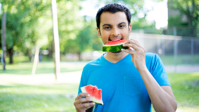 Indian man eating fruits