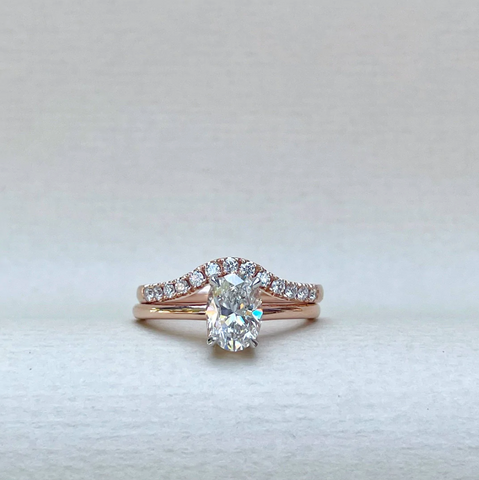 oval-cut-diamond-engagement-ring-stacked-with-rose-gold-diamond-wedding-band
