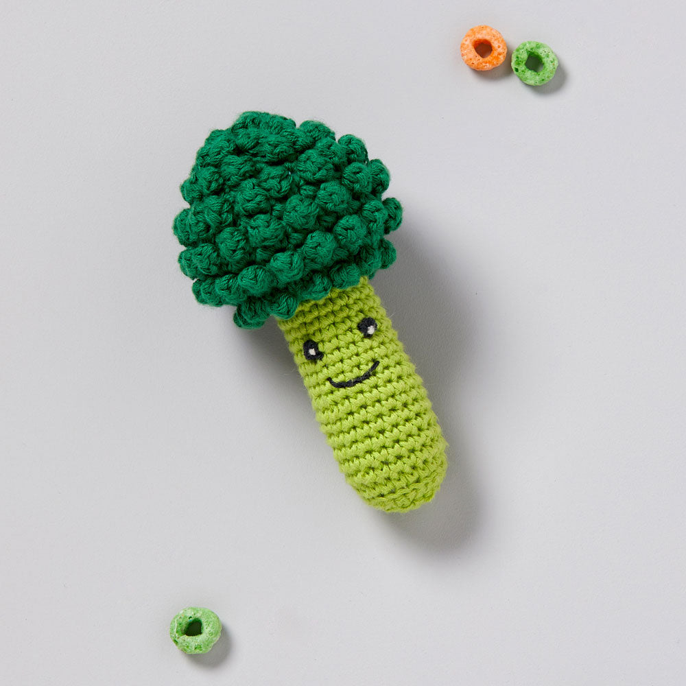 Lifestyle shot of Crochet Rattle Broccoli with froot loop on the sides